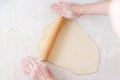 Cooking in the kitchen baking. ÃÂ¡ook rolls out the dough with rolling pin on white background. Royalty Free Stock Photo